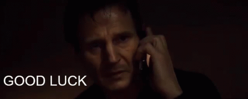 A Man Talking On A Cell Phone With The Words " Good Luck " Behind Him GIF