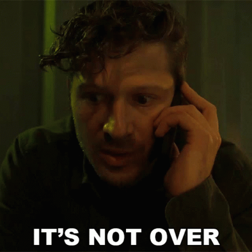 A Man Talking On A Cell Phone With The Words " It 'S Not Over " Behind Him GIF
