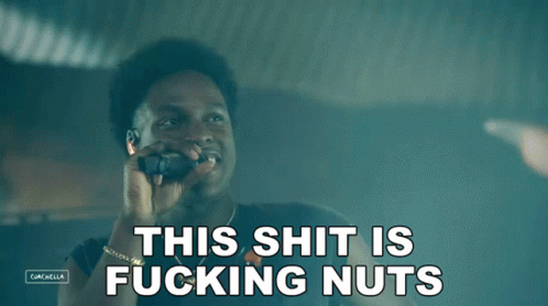 A Man Talking On A Cell Phone With The Words " This Shit Is Fucking Nuts " Above Him GIF