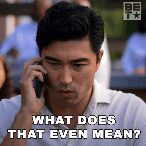 A Man Talking On A Cell Phone With The Words " What Does That Even Mean " Below Him GIF