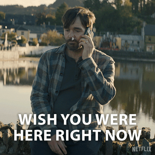 A Man Talking On A Cell Phone With The Words Wish You Were Here Right Now On The Bottom GIF