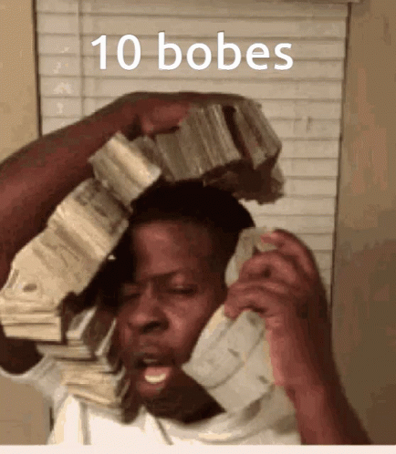 A Man Talking On A Phone With A Stack Of Money On His Head With The Words 10 Bobes Above Him GIF