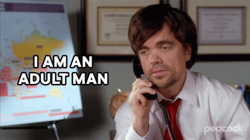 A Man Talking On A Phone With The Words I Am An Adult Man Behind Him GIF
