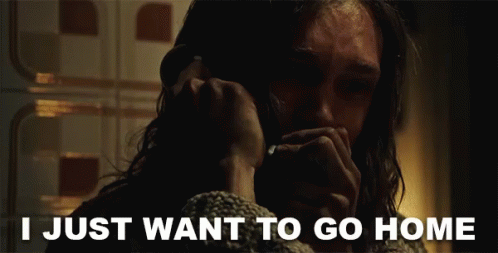 A Man Talking On A Phone With The Words " I Just Want To Go Home " Behind Him GIF