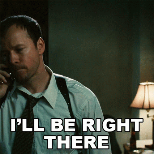 A Man Talking On A Phone With The Words I 'Ll Be Right There Written Below Him GIF