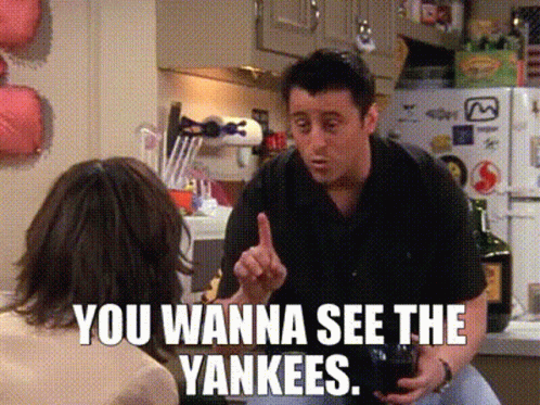 A Man Talking To A Woman In A Kitchen With The Words You Wanna See The Yankees On The Bottom GIF