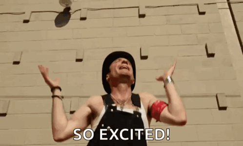 A Man Throws A Ball In The Air With The Words So Excited Behind Him GIF