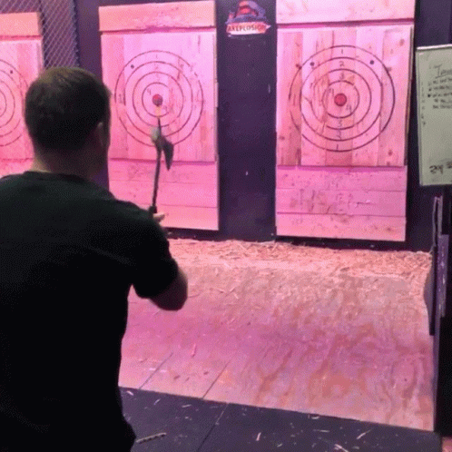 A Man Throws An Axe At A Target That Says " Axelot " On It GIF