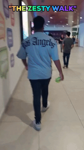 A Man Walking Down A Hallway With The Words " The Zesty Walk " Above Him GIF