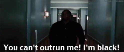 A Man Walking Down A Hallway With The Words " You Can 'T Outrun Me I 'M Black " On The Bottom GIF
