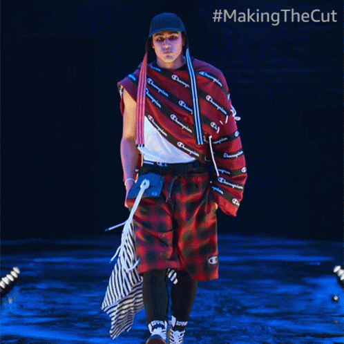 A Man Walking Down A Runway With #Makingthecut Written On The Bottom GIF