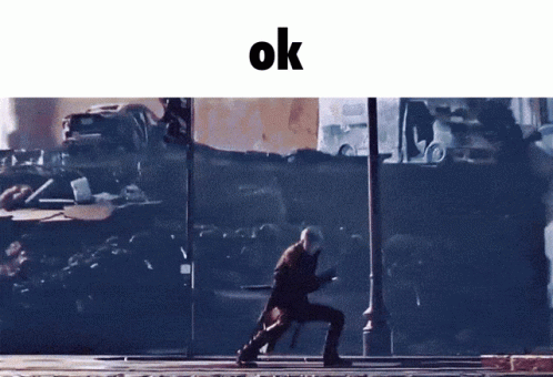 A Man Walking Down A Street With The Word Ok On The Bottom GIF