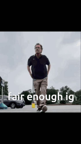 A Man Walking In A Parking Lot With The Words Fair Enough Ig Written On The Bottom GIF