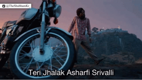 A Man Walking In Front Of A Motorcycle That Says Teri Jhalak Ashari Srivali GIF