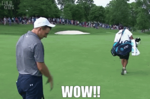 A Man Walking On A Golf Course With A Bag That Has At & T On It GIF