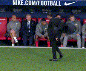 A Man Walking On A Soccer Field In Front Of A Nike.com/football Banner GIF
