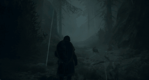 A Man Walking Through A Foggy Forest With A Backpack GIF