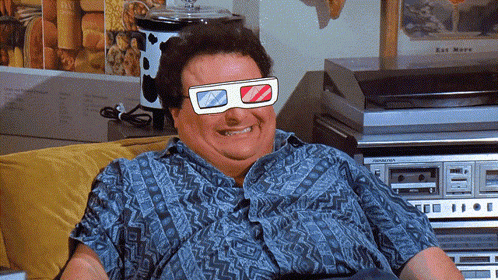 A Man Wearing 3D Glasses Sits On A Couch In Front Of A Pioneer Stereo GIF