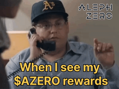 A Man Wearing A A 'S Hat Is Talking On A Phone GIF