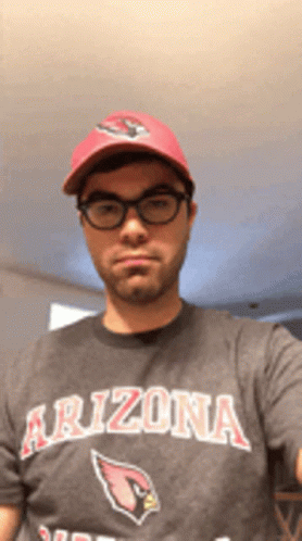 A Man Wearing A Arizona T-Shirt And A Red Hat Takes A Selfie GIF