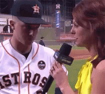 A Man Wearing A Astros Jersey Is Being Interviewed By A Woman GIF