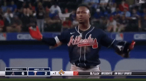 A Man Wearing A Atlanta Braves Jersey Stands On A Baseball Field GIF