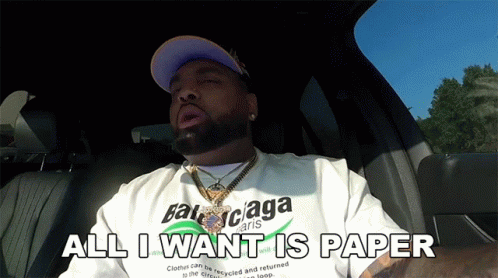 A Man Wearing A Balenciaga Shirt Is Sitting In A Car And Saying All I Want Is Paper GIF