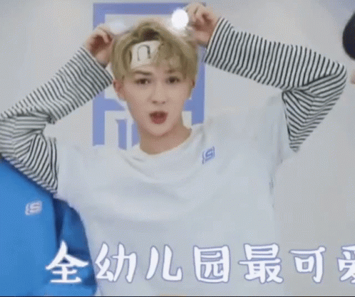 A Man Wearing A Bandana On His Forehead Is Standing Next To Another Man . GIF