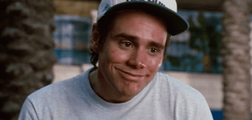 A Man Wearing A Baseball Cap And A Gray Shirt Smiles GIF