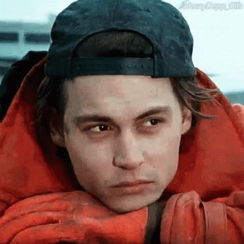 A Man Wearing A Baseball Cap And A Red Jacket GIF