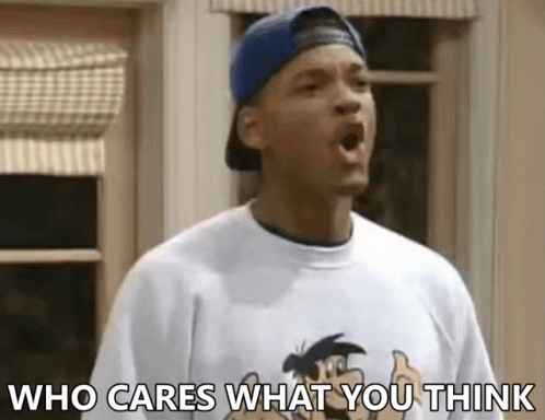 A Man Wearing A Baseball Cap And A T-Shirt With The Words Who Cares What You Think On It GIF