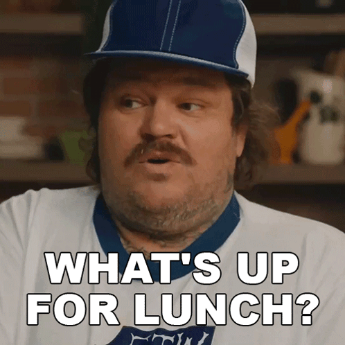 A Man Wearing A Baseball Cap And A White Shirt Says What 'S Up For Lunch GIF