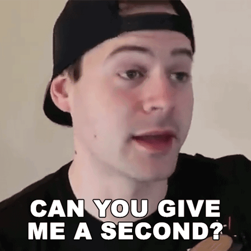 A Man Wearing A Baseball Cap Is Asking If He Can Give Me A Second GIF