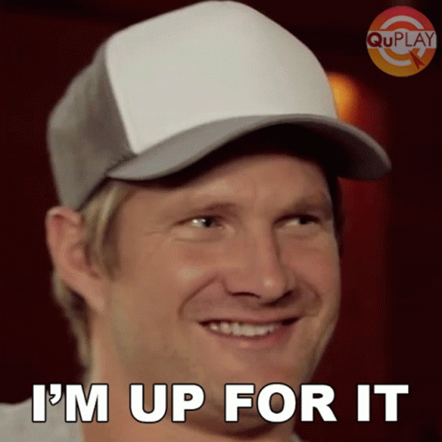 A Man Wearing A Baseball Cap Is Smiling And Says I 'M Up For It GIF