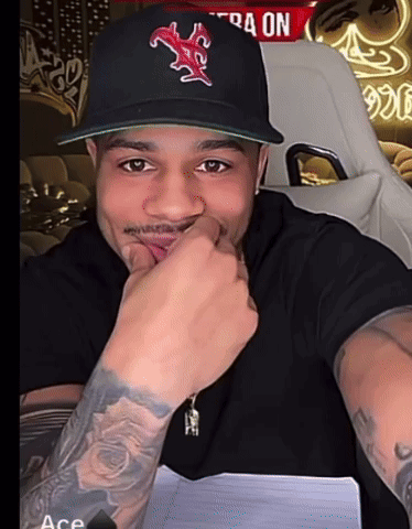 A Man Wearing A Baseball Cap With A Red Star On It GIF