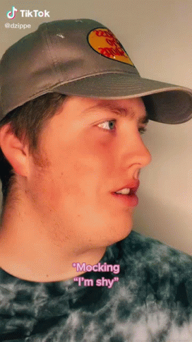 A Man Wearing A Bass Pro Shops Hat Says " Mocking " I 'M Shy " GIF