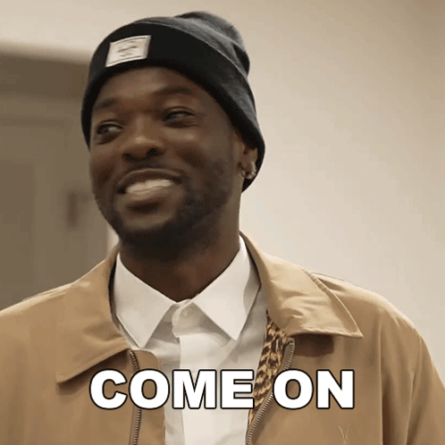 A Man Wearing A Beanie And A Jacket Is Smiling And Says Come On GIF