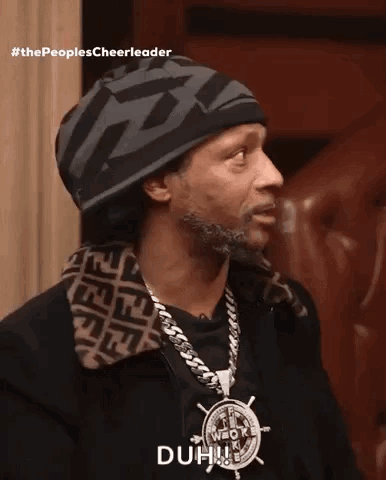 A Man Wearing A Beanie And A Necklace Says Duh GIF