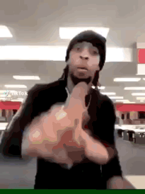 A Man Wearing A Beanie And Sunglasses Is Giving The Middle Finger GIF