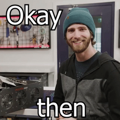 A Man Wearing A Beanie Is Smiling With The Words Okay Then Above Him GIF