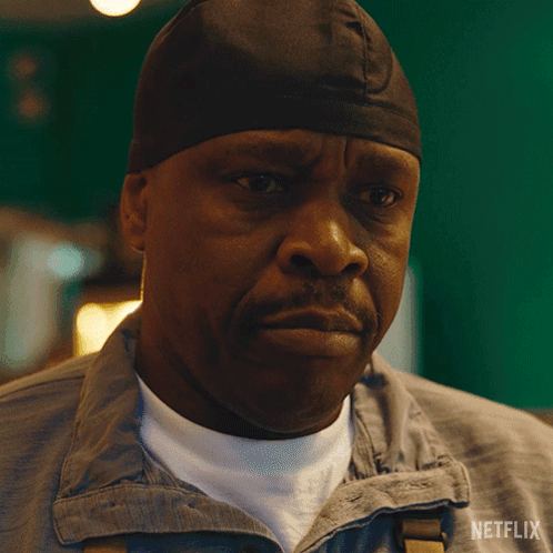 A Man Wearing A Beanie Says Please In A Netflix Advertisement GIF