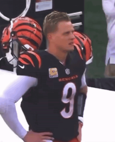 A Man Wearing A Bengals Jersey With The Number 9 GIF