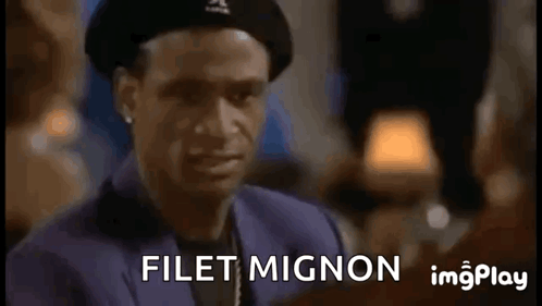 A Man Wearing A Beret Is Making A Funny Face And Says Filet Mignon GIF