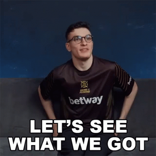 A Man Wearing A Betway Shirt Is Sitting On A Couch And Says Let 'S See What We Got . GIF