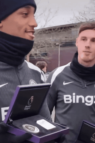 A Man Wearing A Bing Shirt Holds A Box GIF