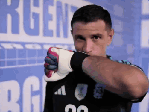 A Man Wearing A Black Adidas Jersey With The Number 20 On The Front GIF