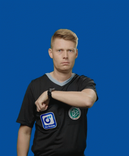 A Man Wearing A Black Adidas Shirt Holds Up A Yellow Card GIF