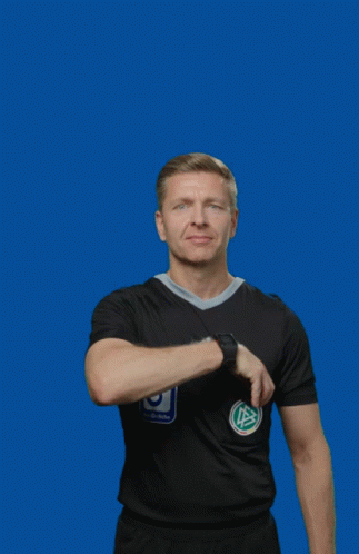 A Man Wearing A Black Adidas Shirt Holds Up A Yellow Card GIF