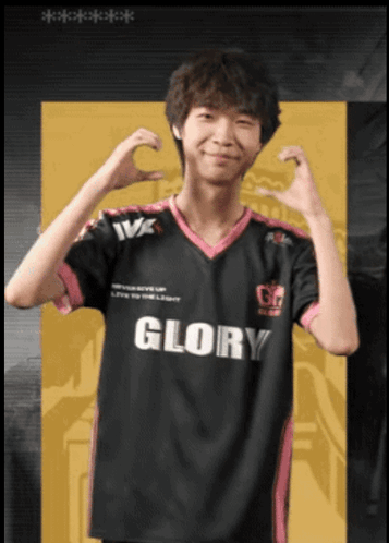 A Man Wearing A Black And Pink Glory Jersey Makes A Heart Shape With His Hands GIF