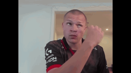 a man wearing a black and red shirt that says adn